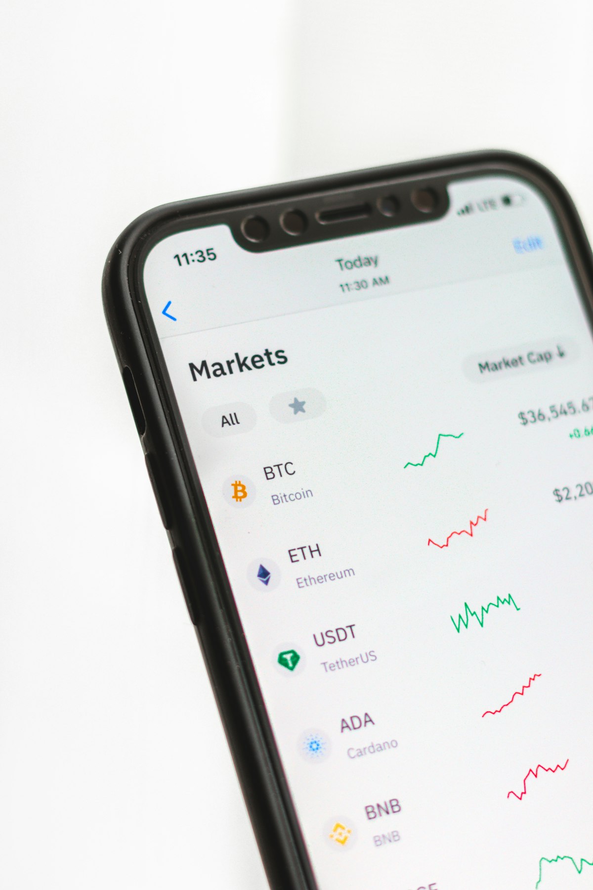 A phone showing a crypto markets screener